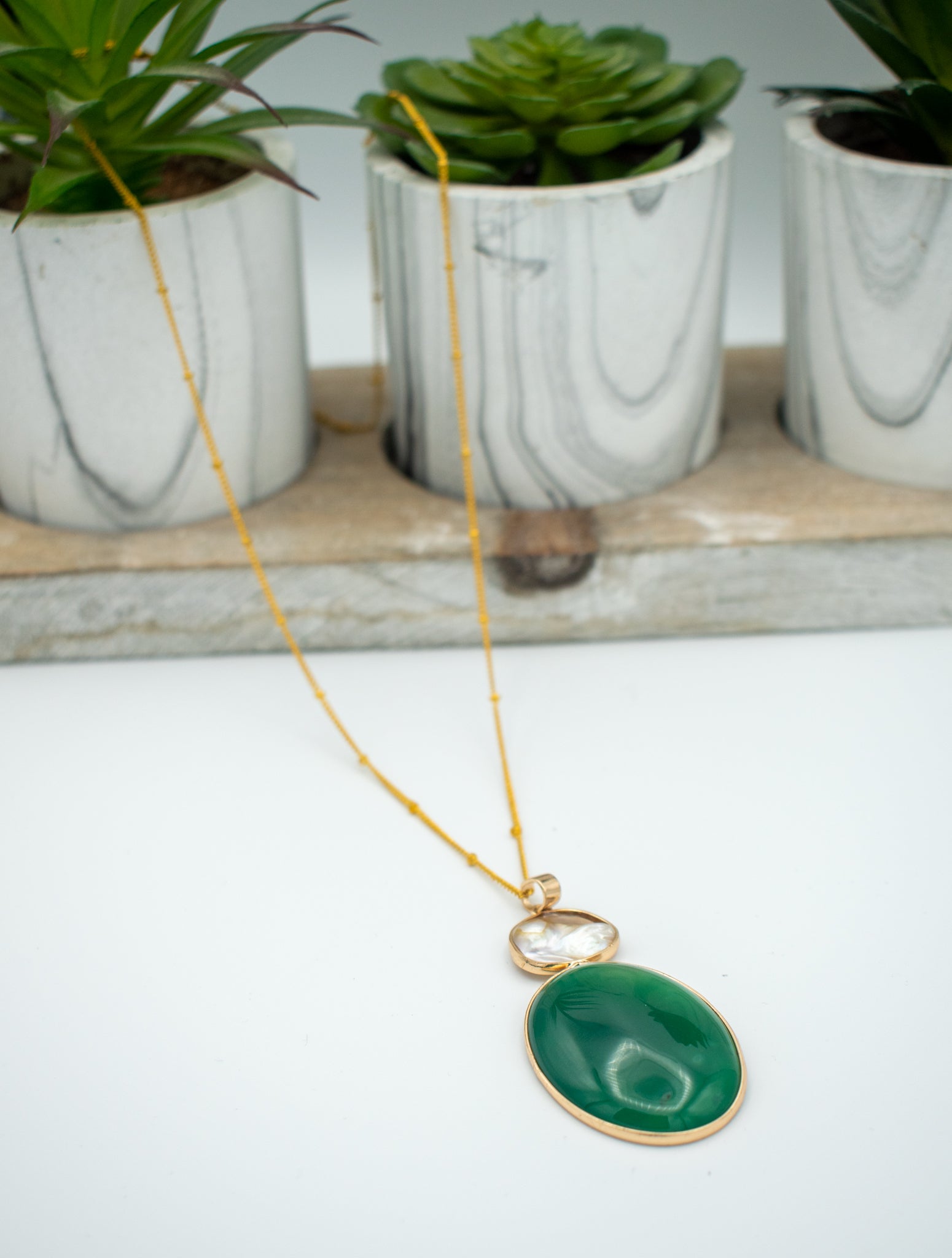 view of a Aubry Gold Necklace with green jade stone