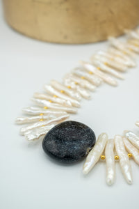 closeup of stick pearl ceramic necklace