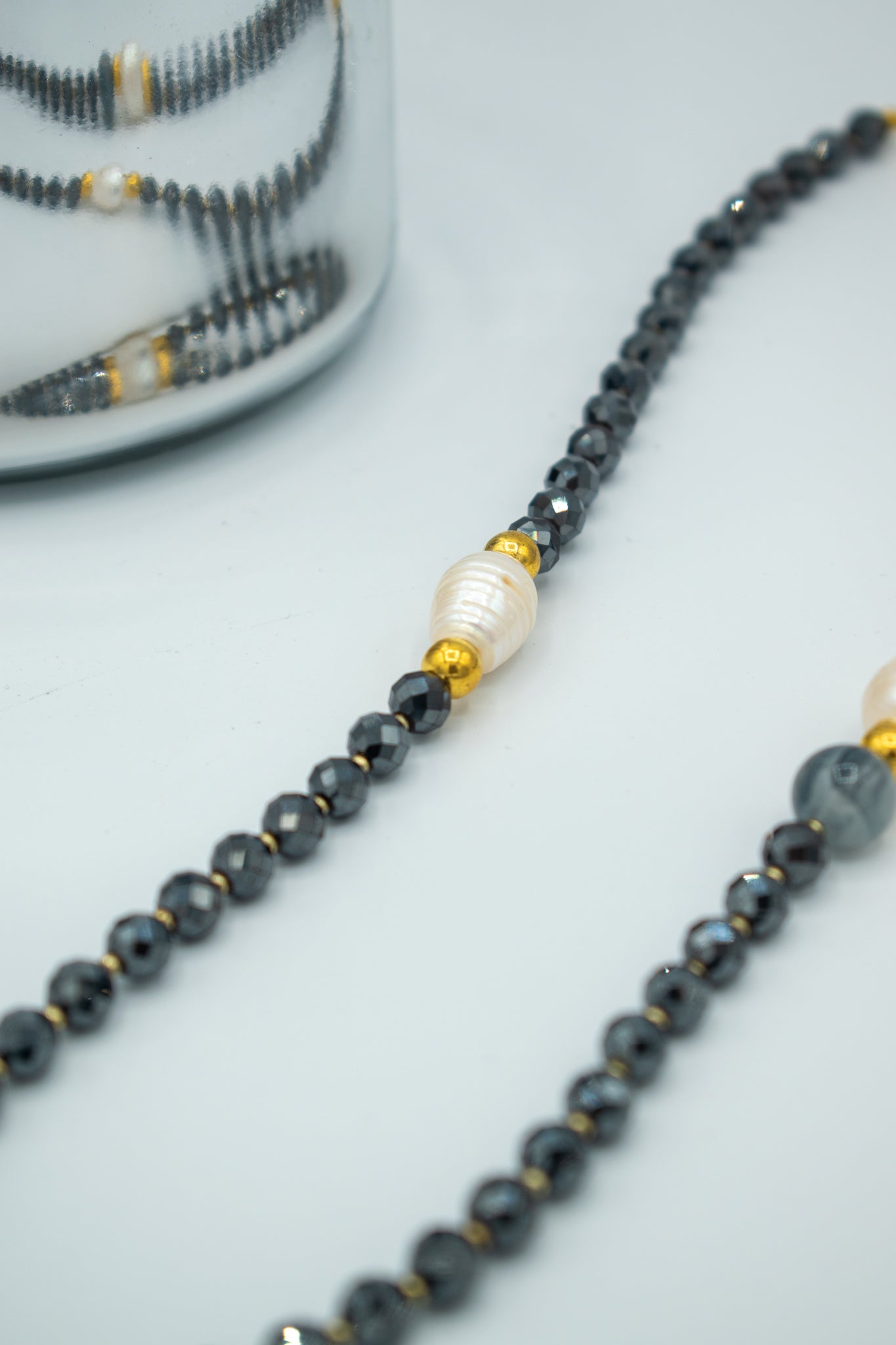 closeup of Shiny black, gold and pearls