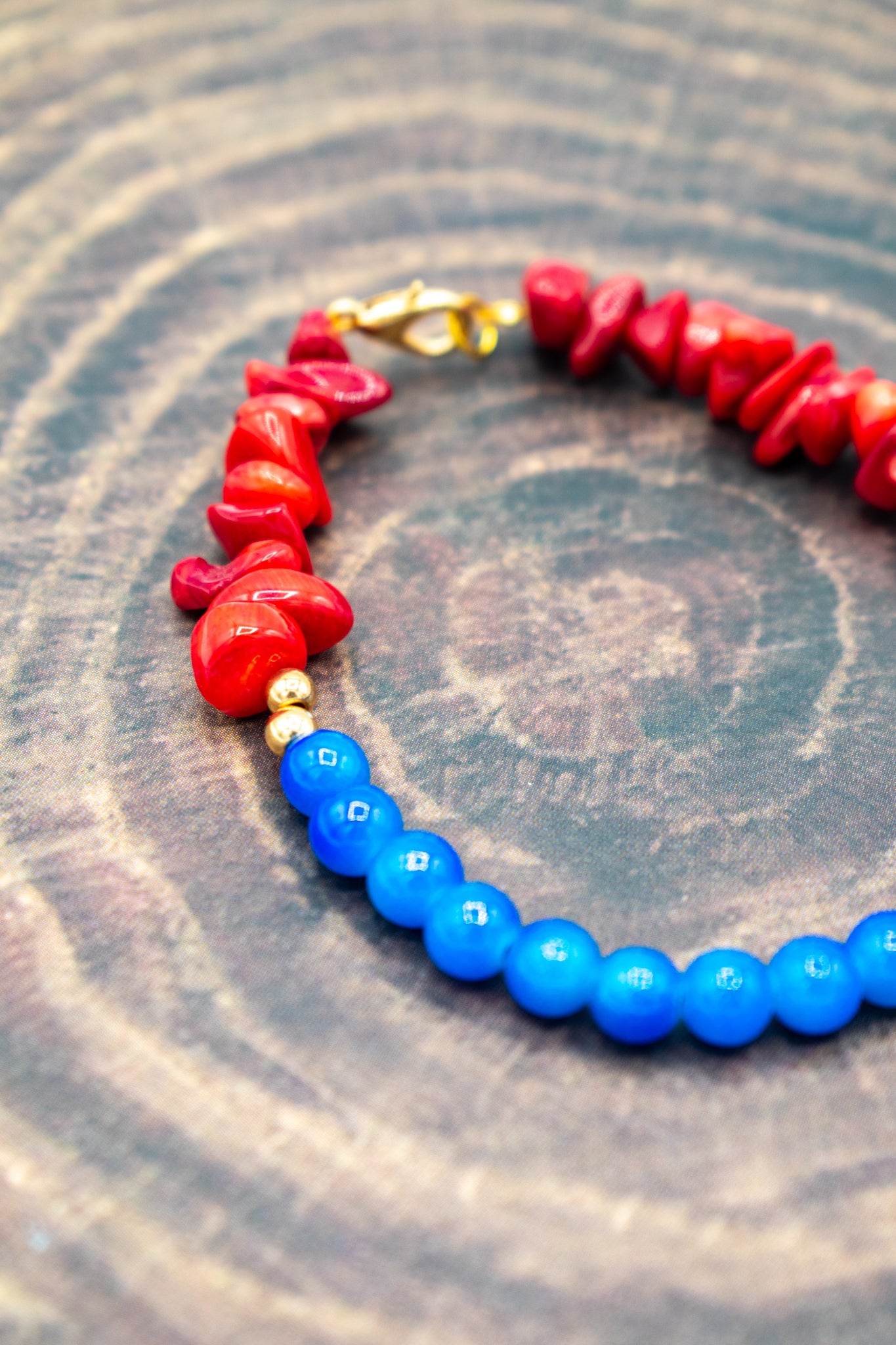 side view of blue Jade healing stones with deep red Coral beads bracelet 