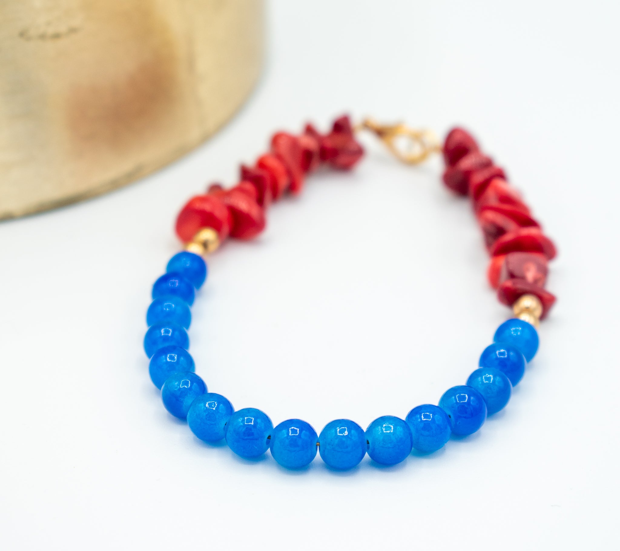 closeup of blue Jade healing stones with deep red Coral beads bracelet 