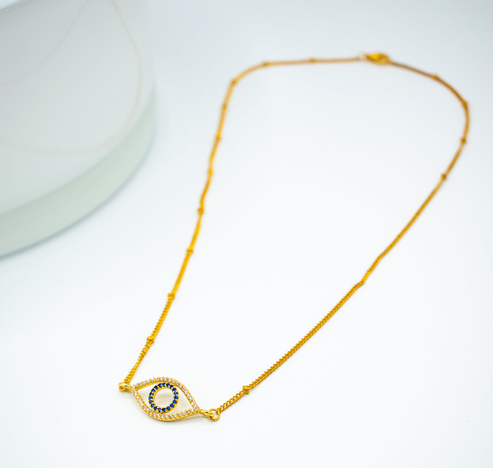 Gold colored shiny evil eye