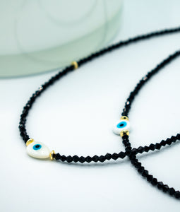 closeup of lack beads with evil eye chokers