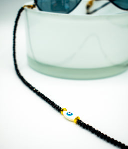 close up of evil eye bead with golden accent