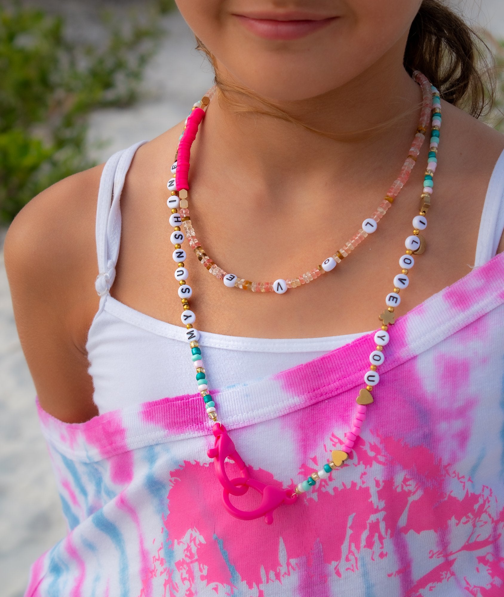 kids wearing a words necklace 