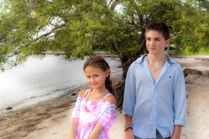 boy wearing I love softball healing stones necklace