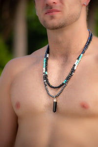 man wearing a Emanuel health Black Beads with a touch of blue and white necklace