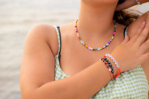 woman wearing a words bracelet and necklace