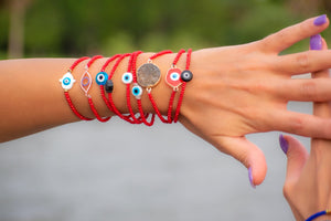 woman wearing Red protection bracelets