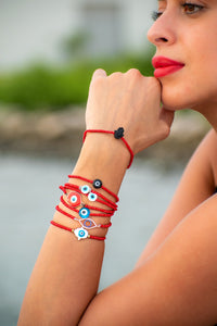 woman wearing Red protection bracelets