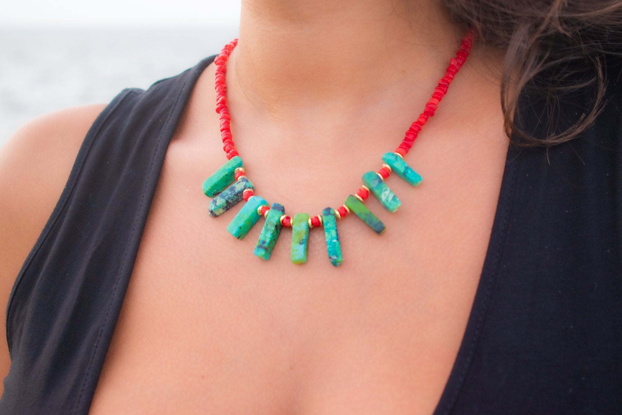 view of woman wearing Green crown healing necklace