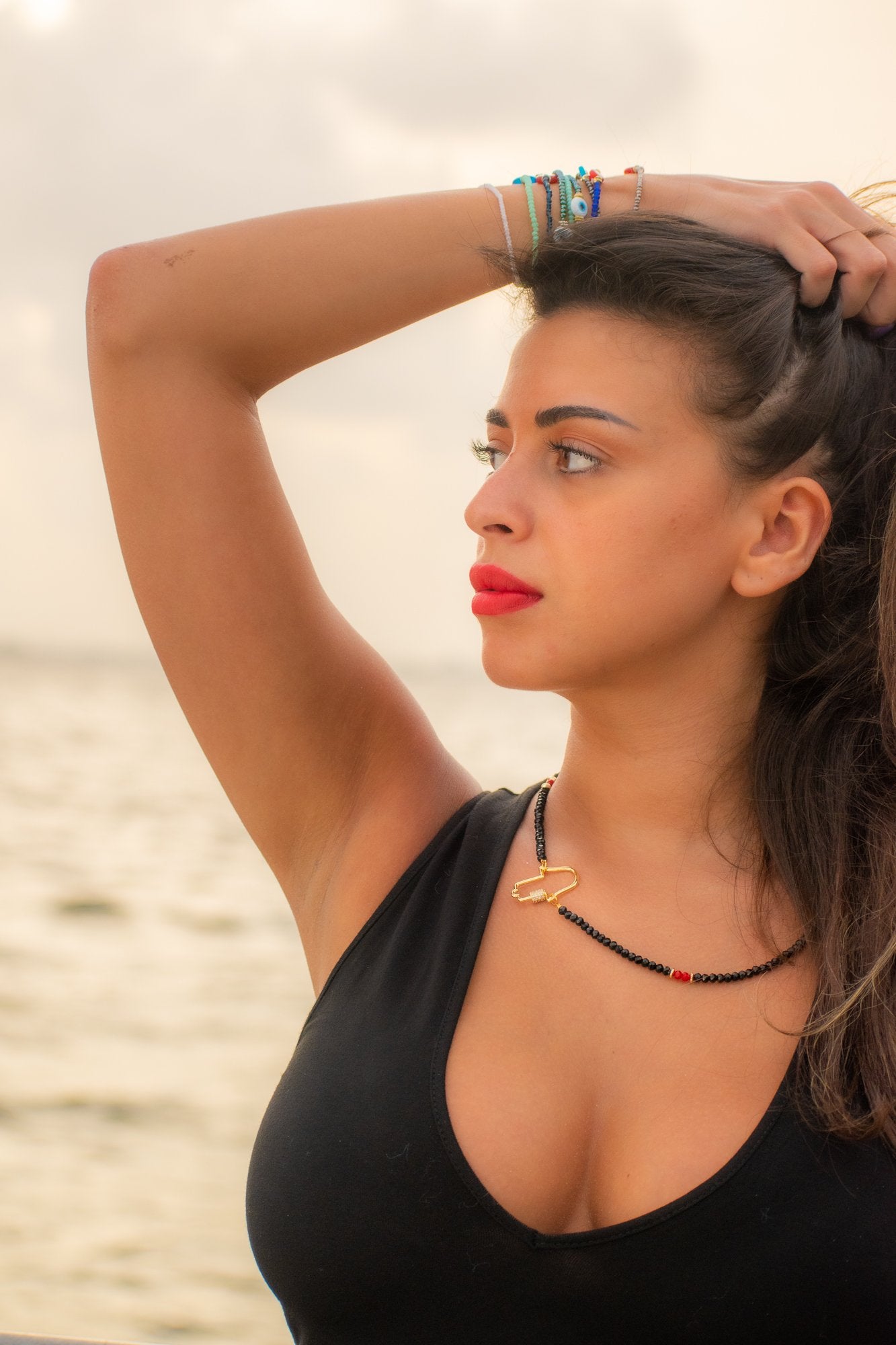 side view of a woman wearing Marrakesh Gold Hamsa necklace