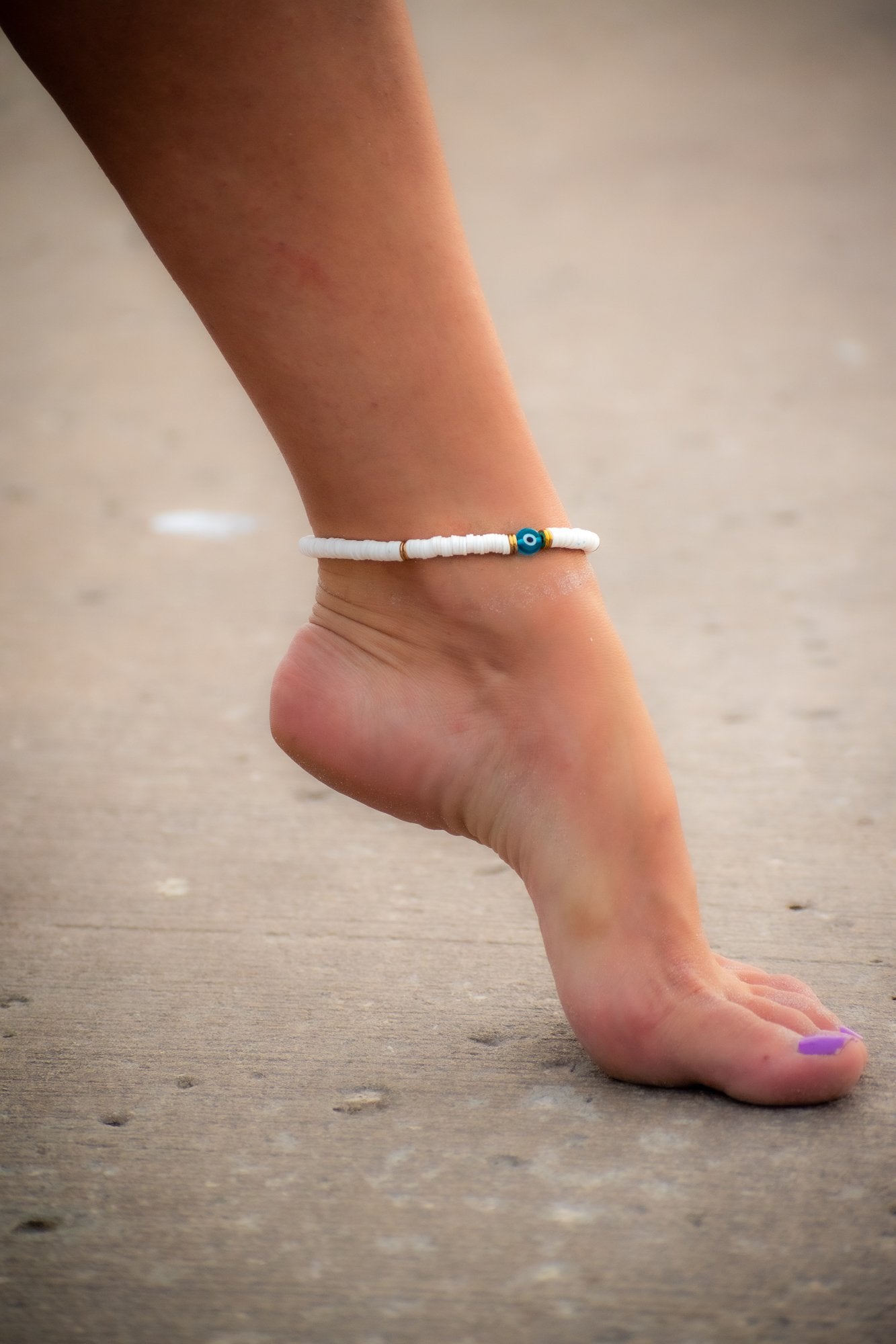 woman wearing Abigail White Evil Eye anklet