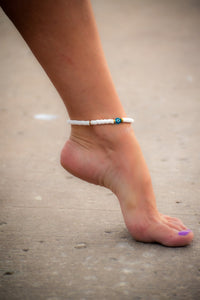 Woman wearing White Evil Eye anklet